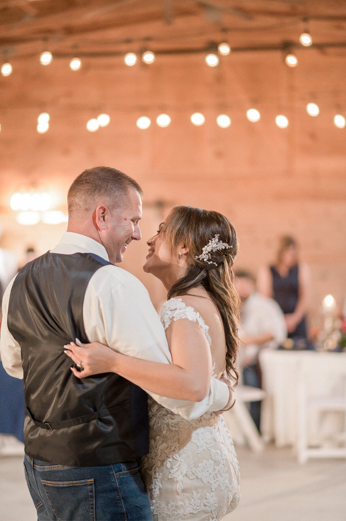 The bride & groom hold each other tightly during their first dance at their wedding reception.  Photographed by Colorado wedding photographer Stephanie Eddy