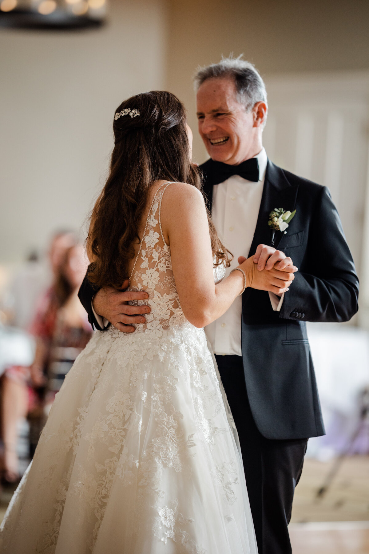 aPhotograph of a father daughter dance at a wedding.