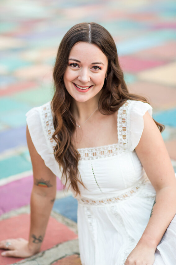 senior girl sitting on colored floor