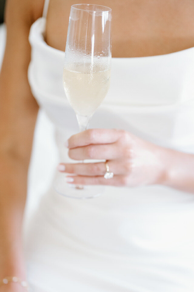 Bride holding champagne
