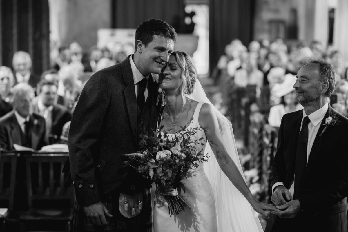 The bride greet the groom at her church wedding ceremony