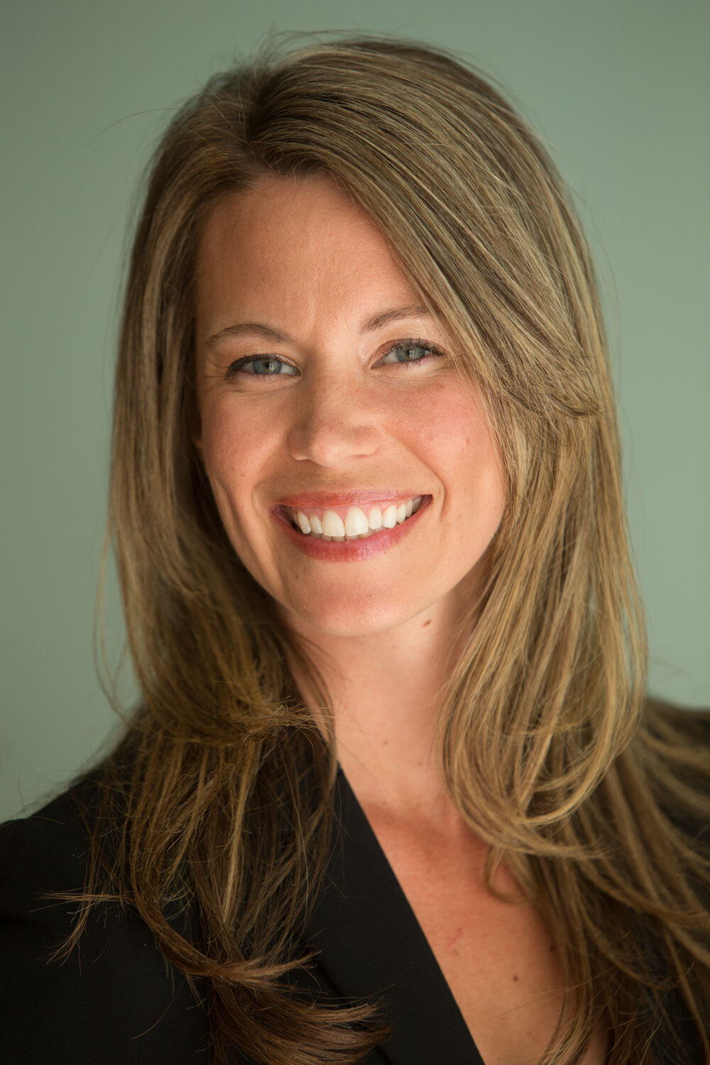 Close-up of smiling woman with long blondish-brown hair