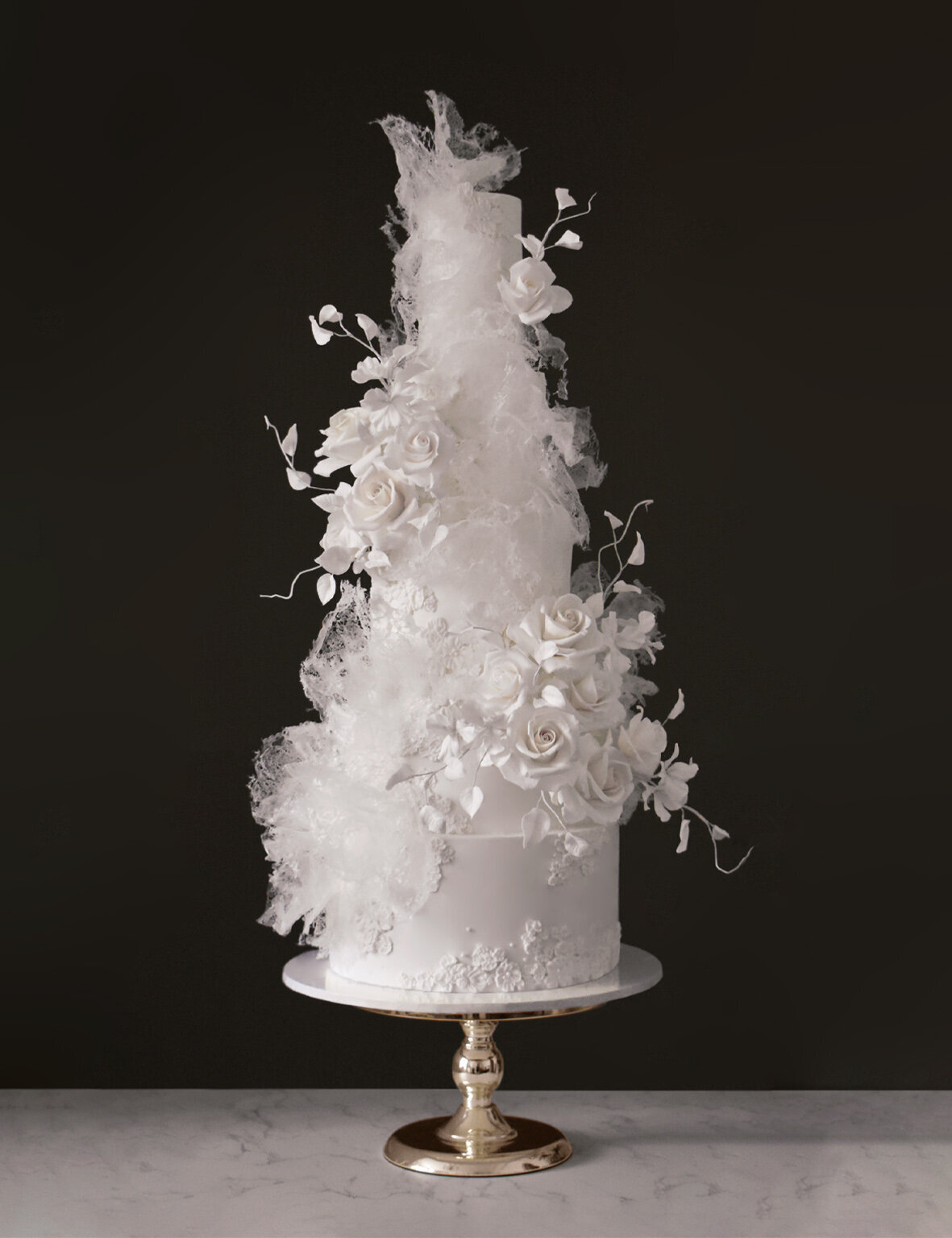 All white wedding cake with abstract textures