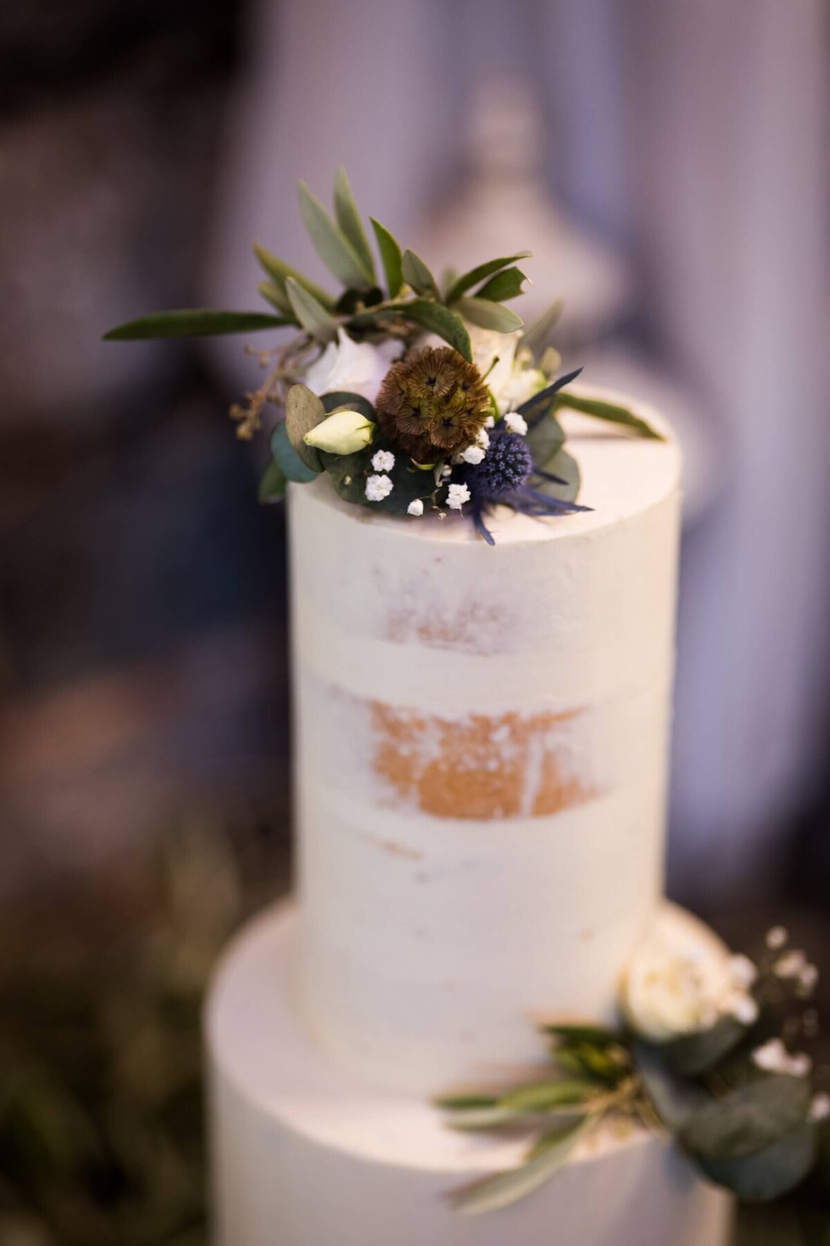 A wedding cake with flowers on top of it