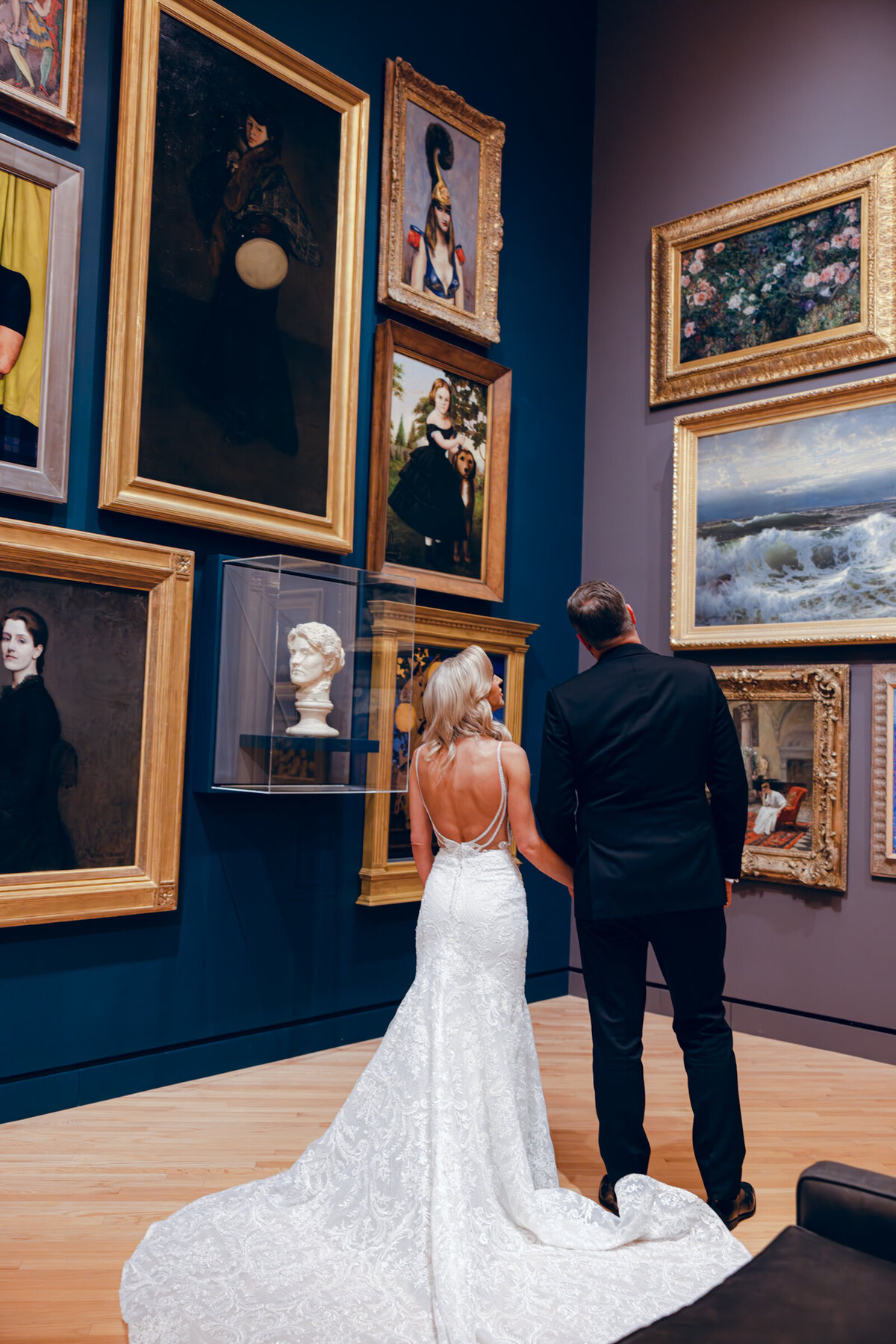 A wedding day photo  of the bride and groom posing for a portrait in Crystal Bridges Museum of American Art in Arkansas