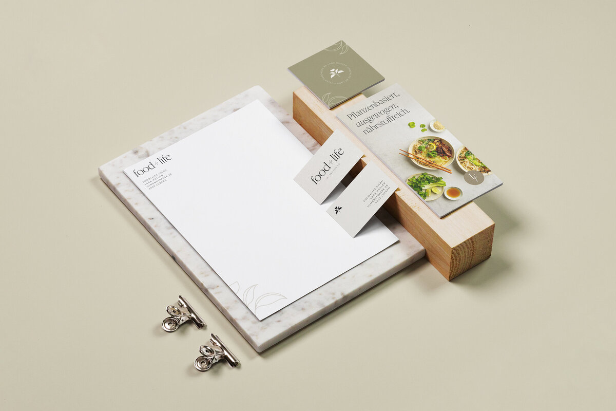 Stationary Mockups on light minimal background showing a letterhead, business cards and flyer with elegant branding for a food photographer
