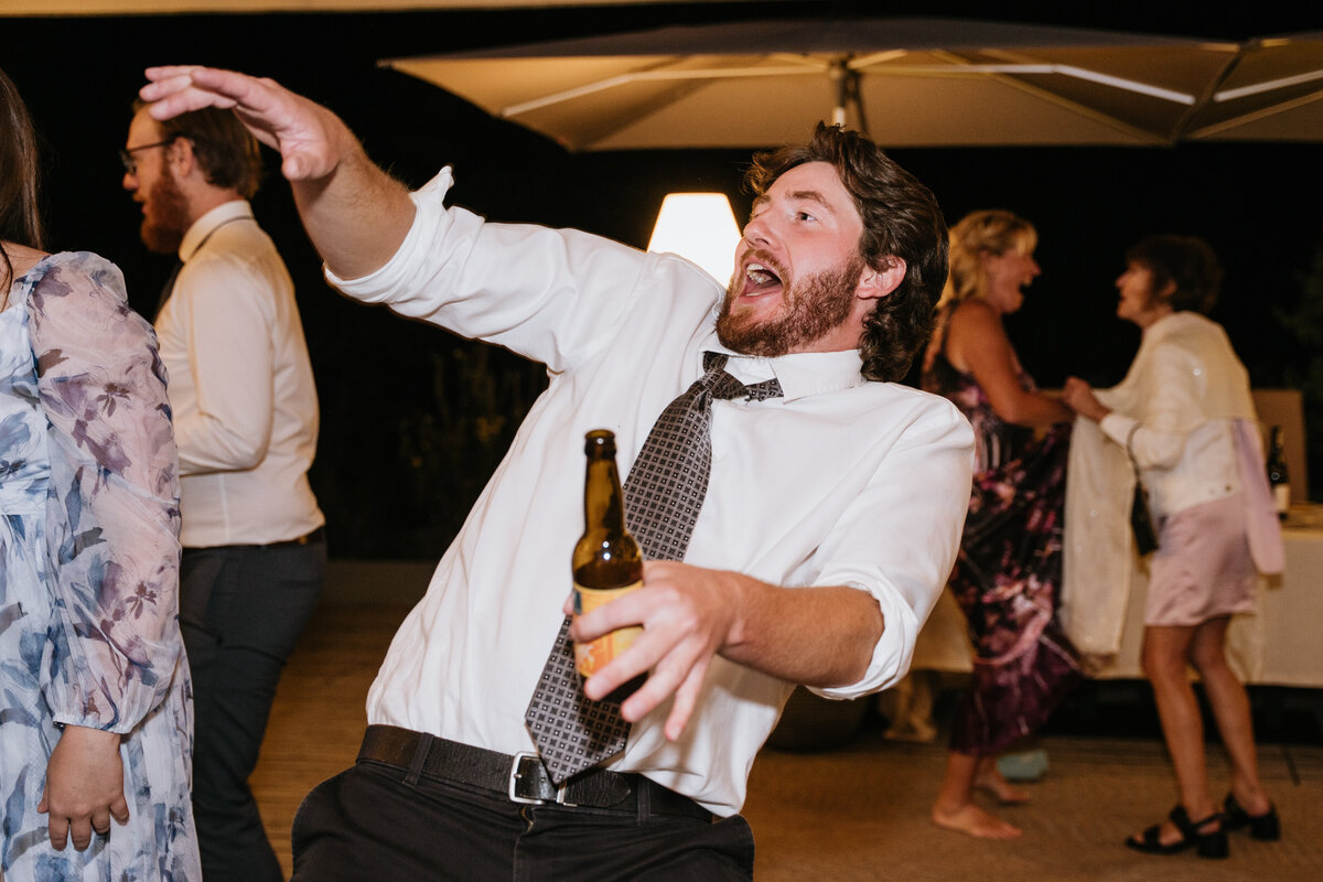 Guests celebrating and dancing at wedding reception