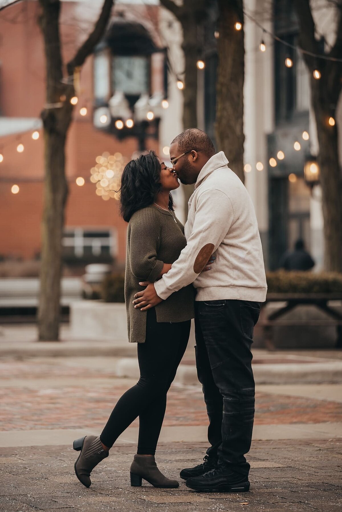 couple kissing in a town square