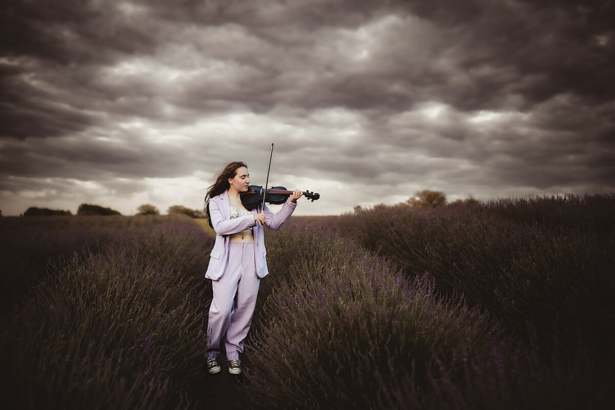 senior playing violin in lavender field