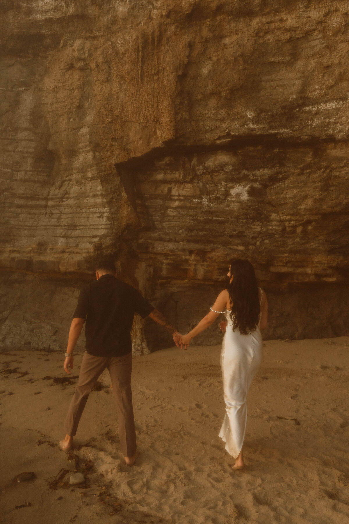 a couple silhouette in front of cliffs