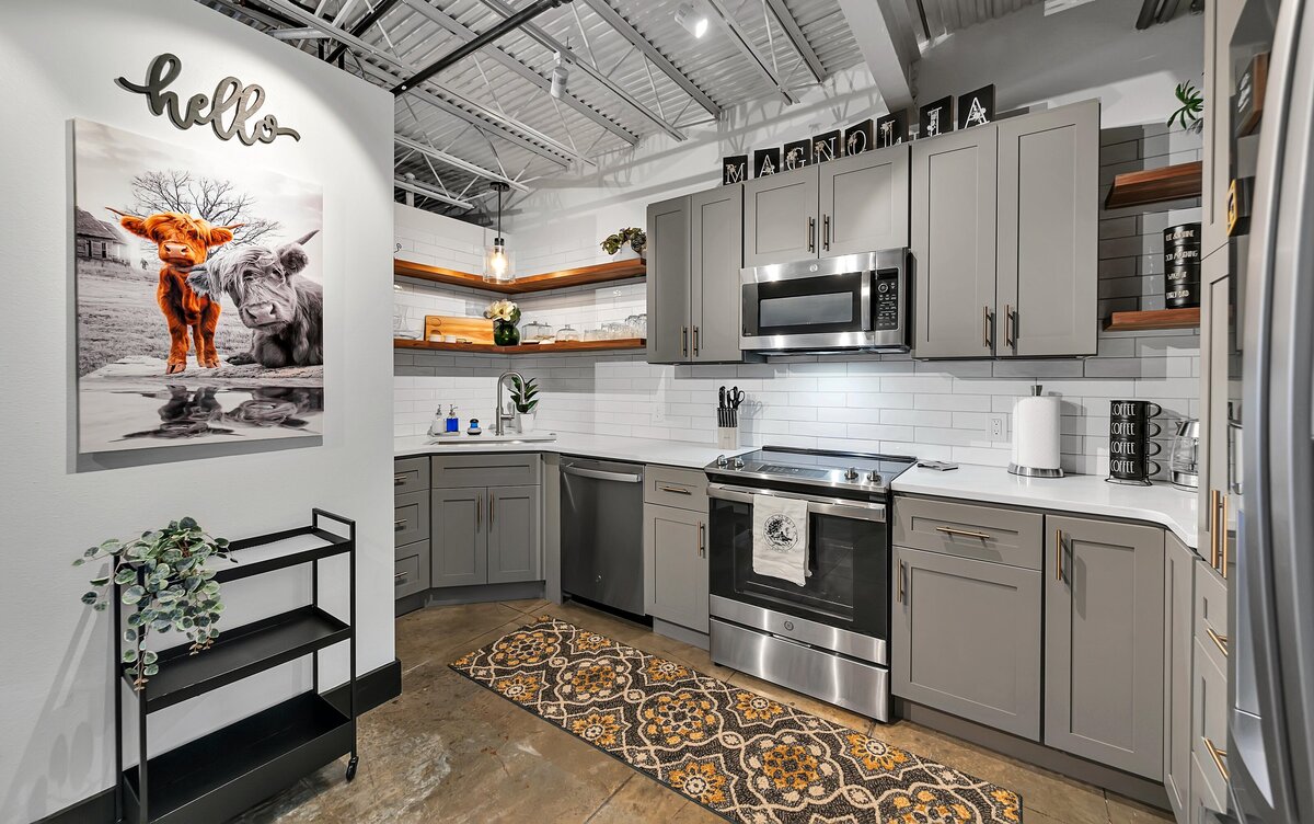 Fully stocked kitchen in this top floor two-story industrial condo in the historic Behrens building with skyline views, fully stocked kitchen and room for 6 in downtown Waco, TX.