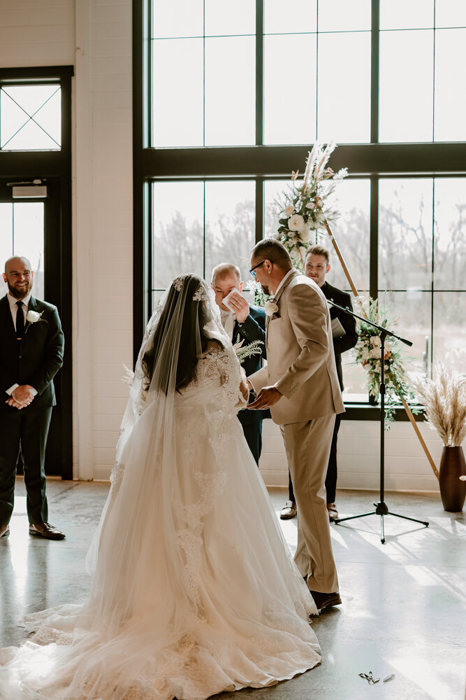 storyteller-collective-photo-co-ceremony-bride-dad-ashton-hill-farm-cedar-rapids-iowa-floral-backdrop