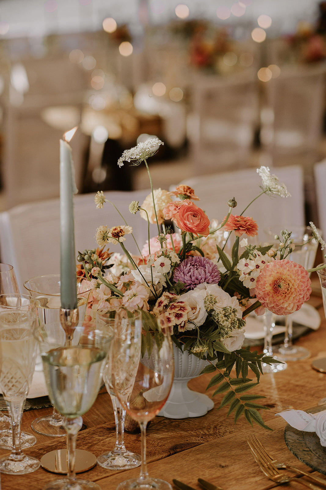 Lush elegant centrepieces of bright flowers at a wedding reception in Montreal.