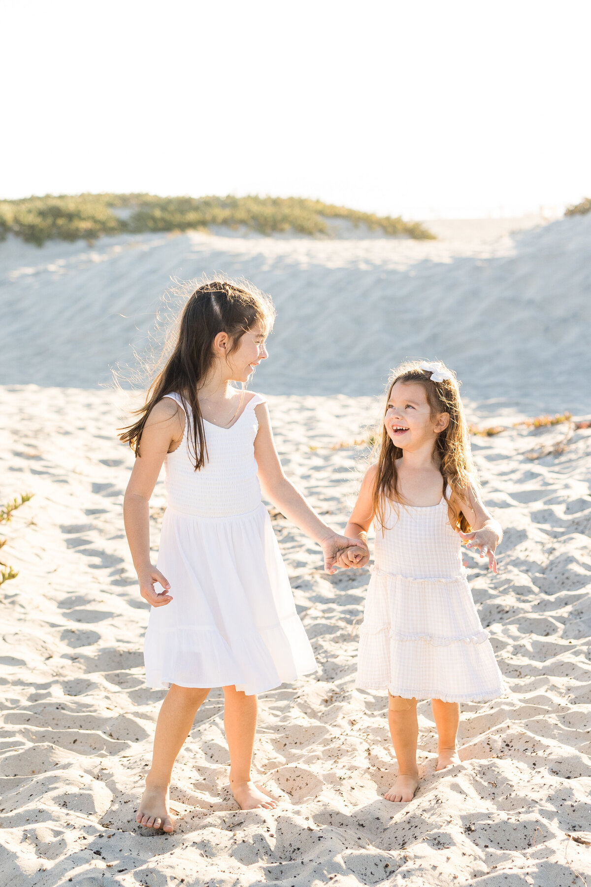 young-girls-walking-on-coronado-beach-san-dunes