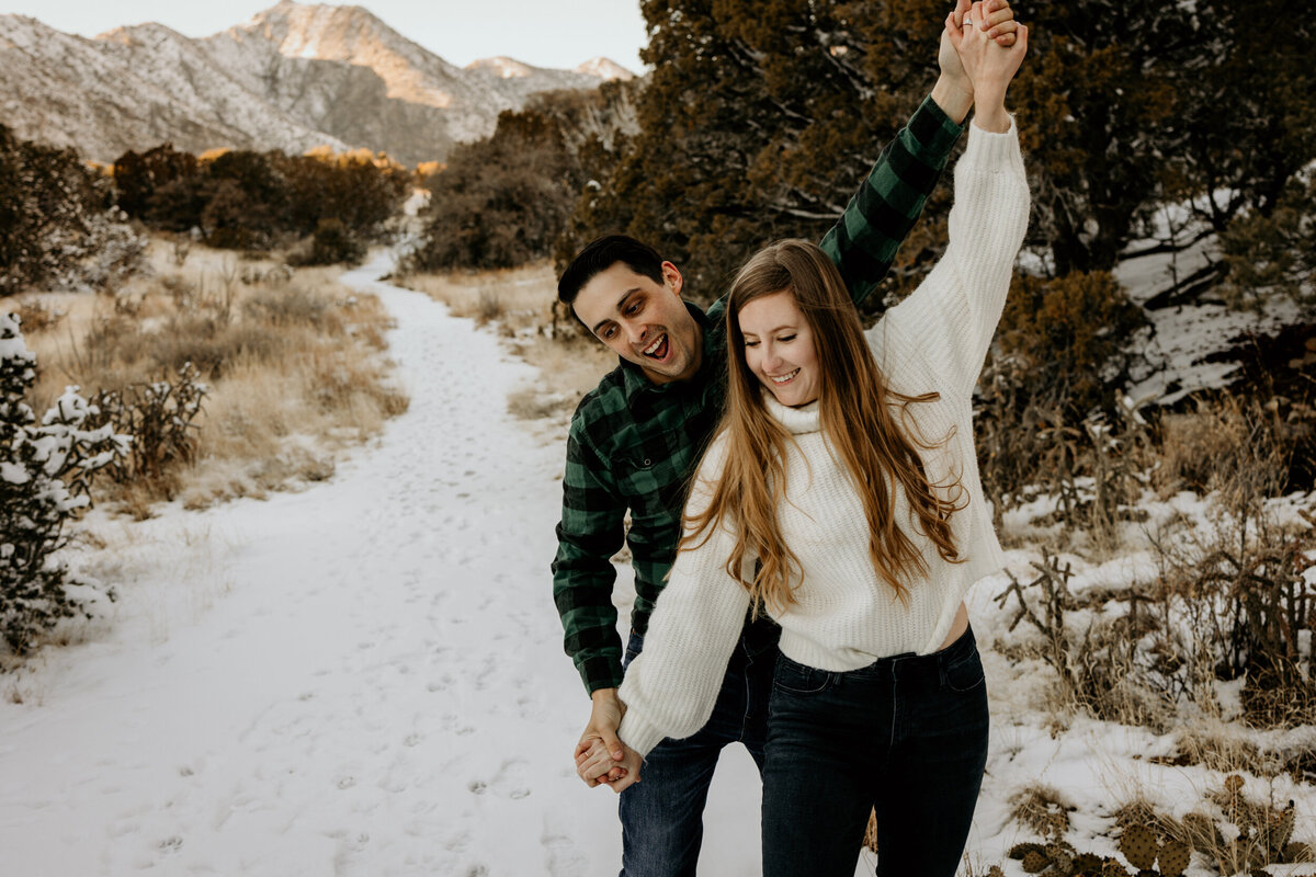 couple walking on the  snowy Sandia foothills in Albuquerque