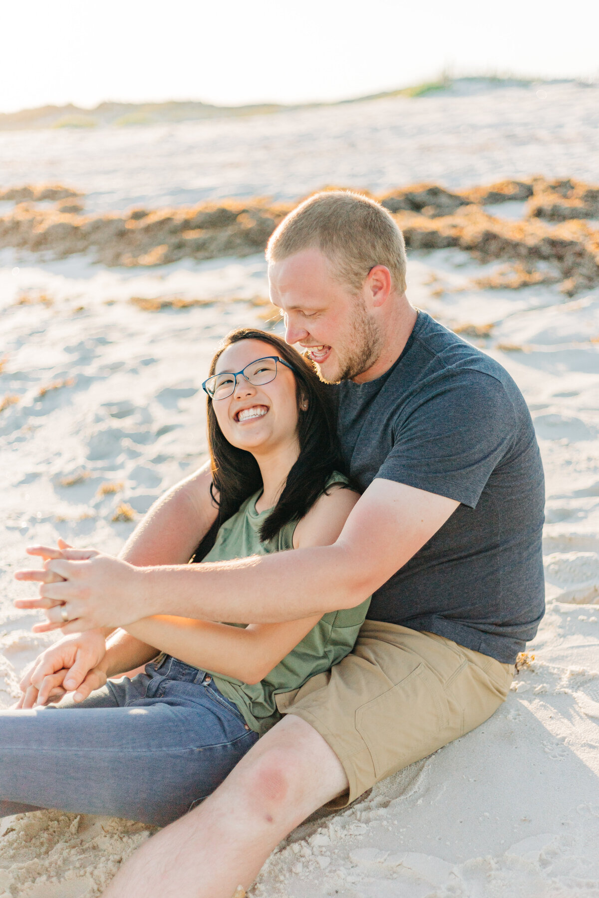 couple sitting on the ground looking at each other