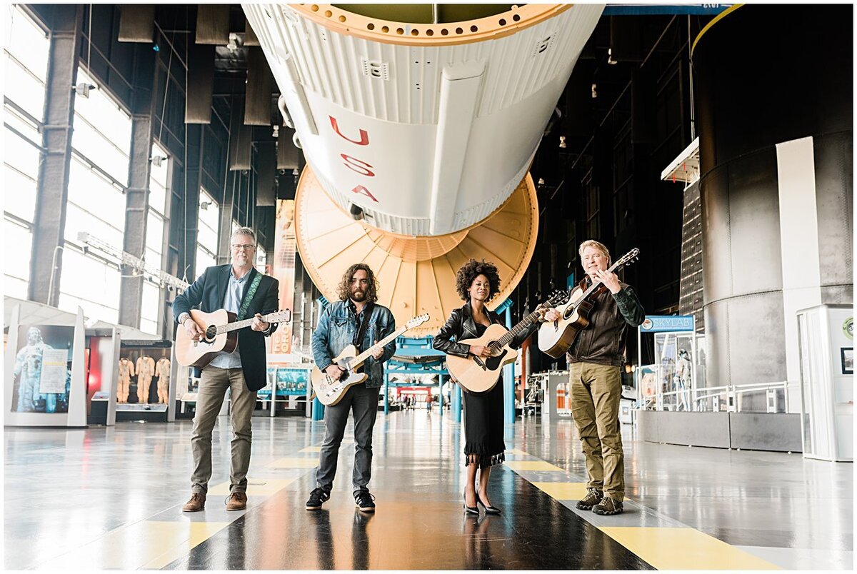 Musicians playing under the Saturn V