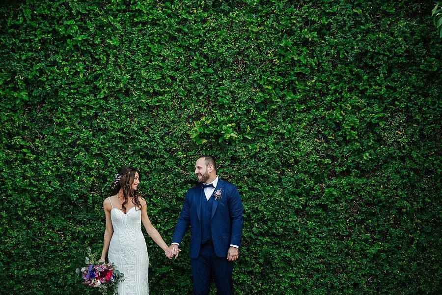 sundy house wedding, couple standing in front of ivy wall
