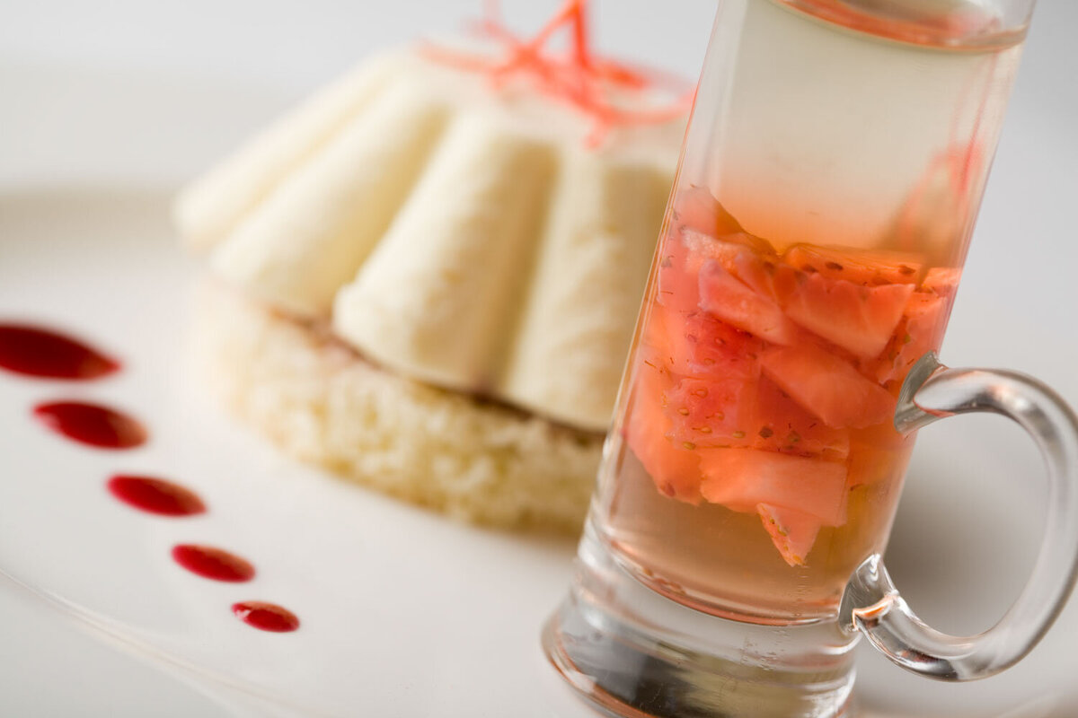 Plated dessert with a shot glass of diced fruit
