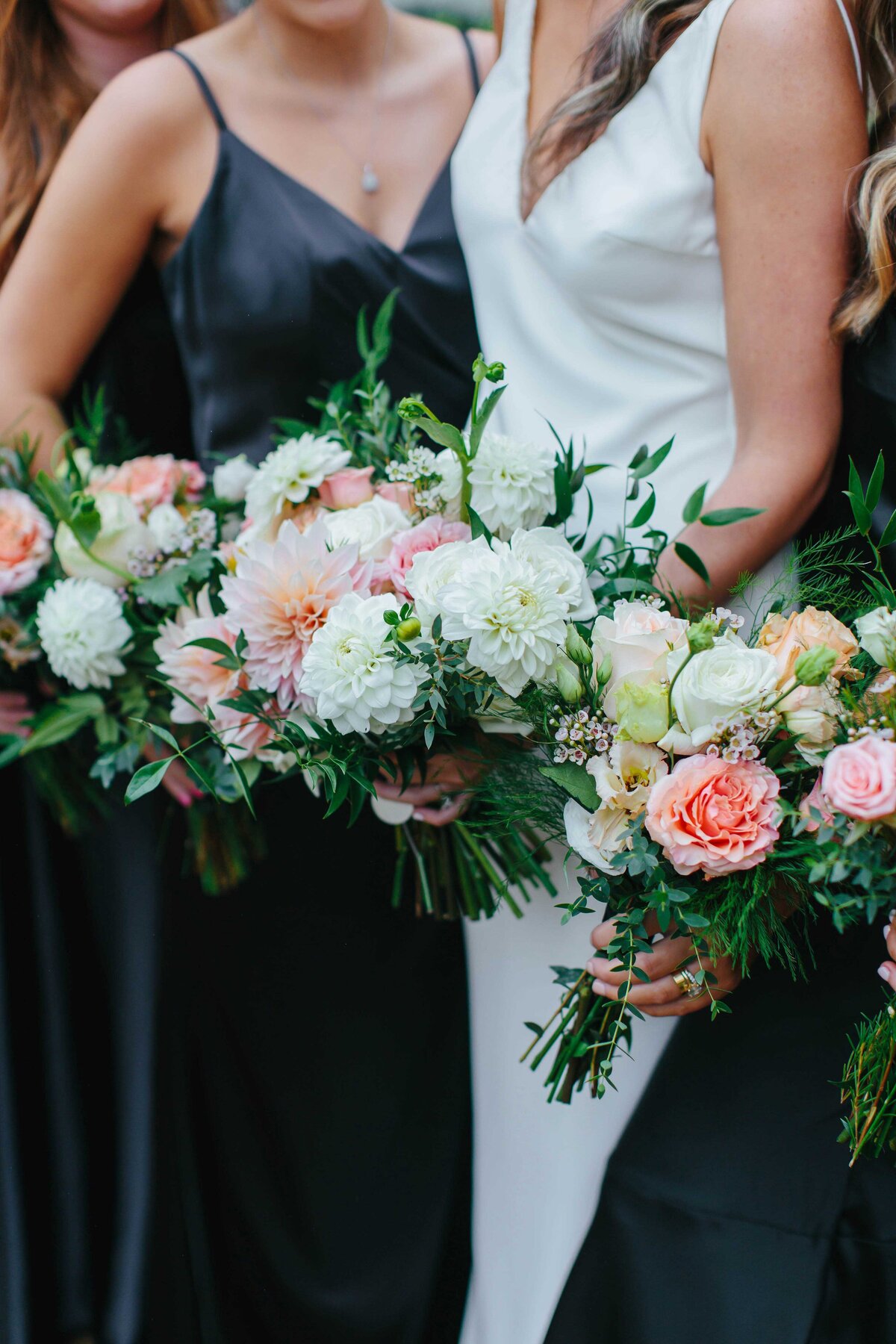 Close up bouquet picture with bride and bridesmaids in the background at Chateau Selah wedding venue in Blountville TN