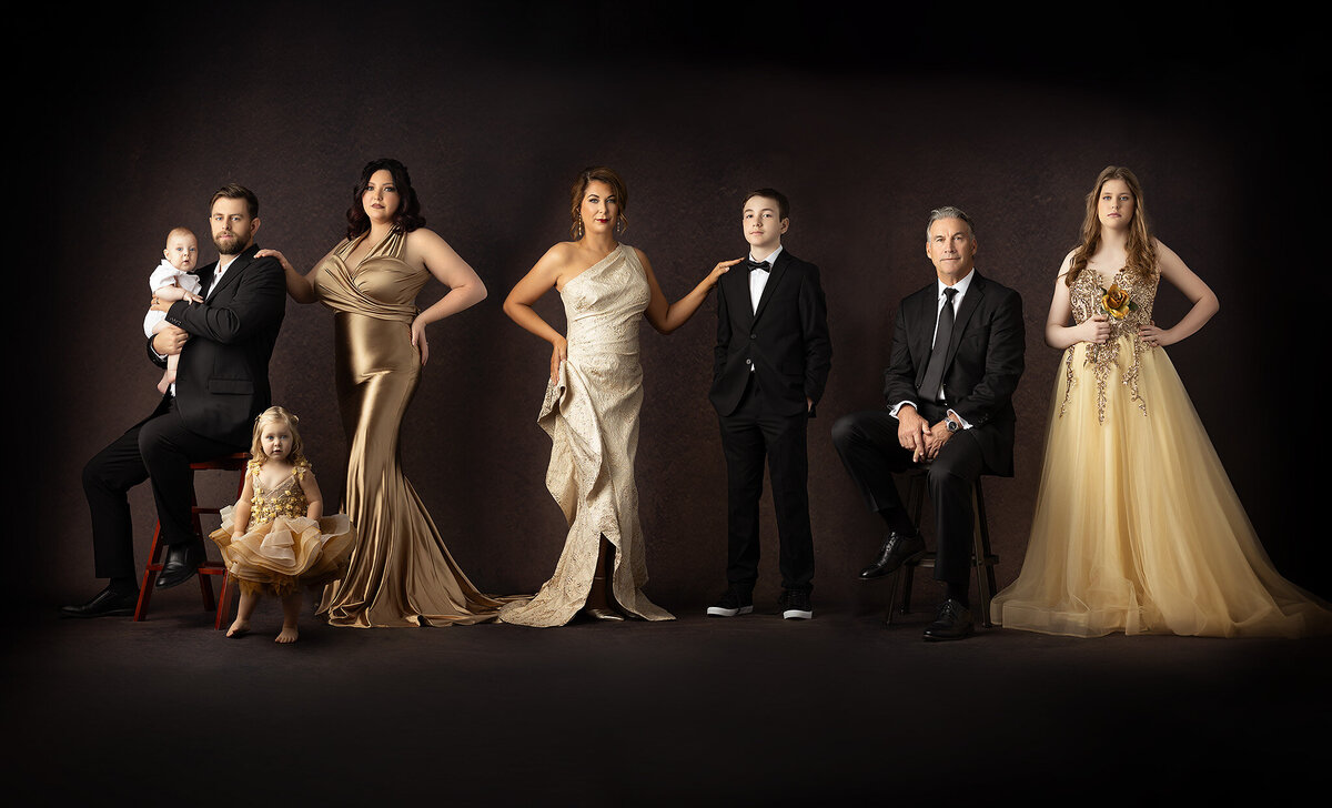Dallas family photographers capture a glamorous family portrait with each member dressed elegantly in coordinated attire.