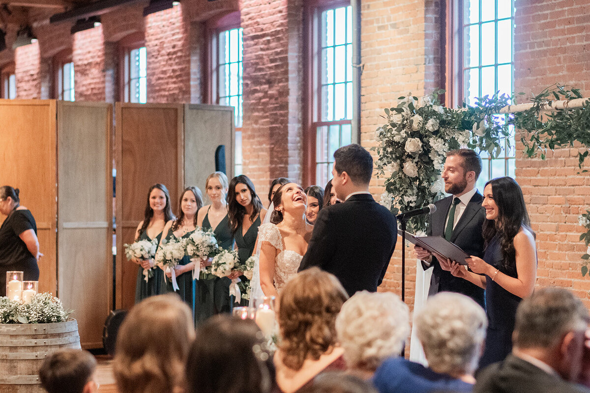 bride has a laugh during her wedding ceremony