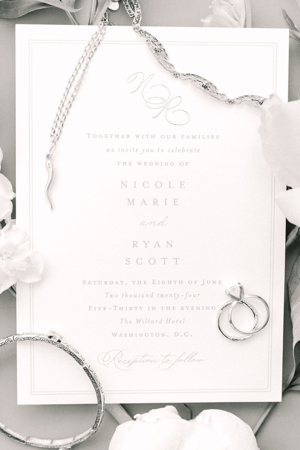 Wedding invitation with rings and jewelry flat lay