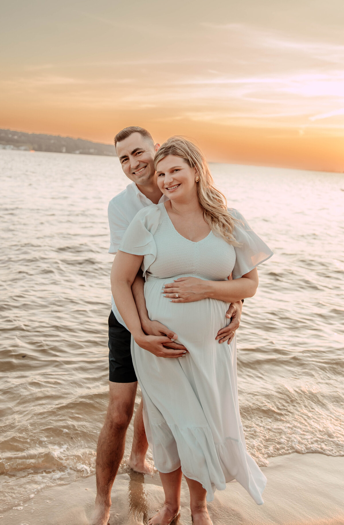 a couple posing for a photo at Sandy Hook Beach