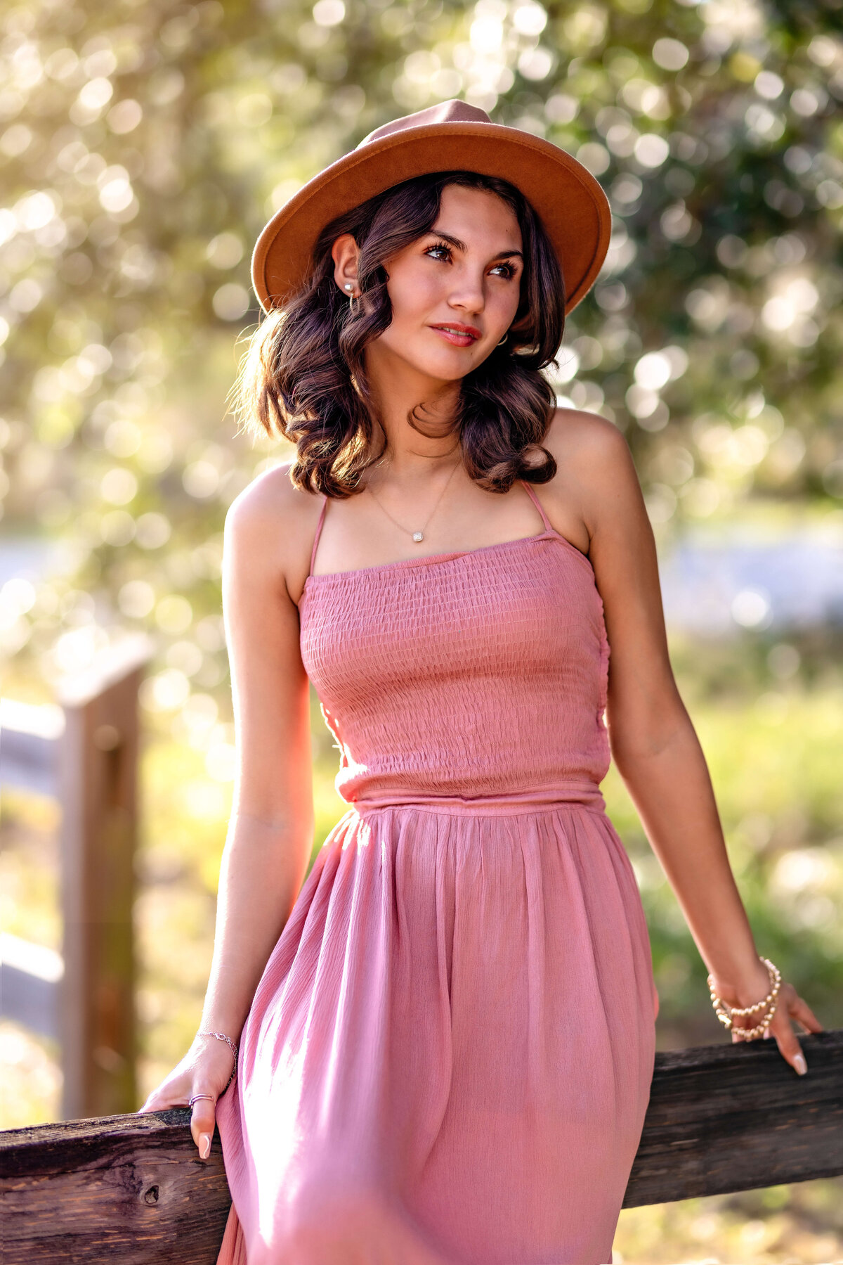 Editorial-style senior photo with confident pose in golden light in Orlando.