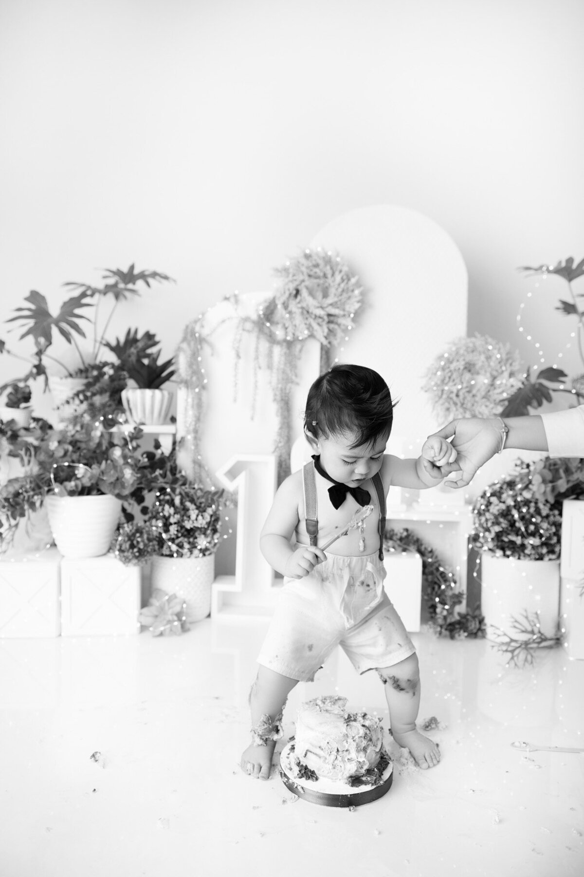 little boy playing with wooden bike at smash the cake shoot