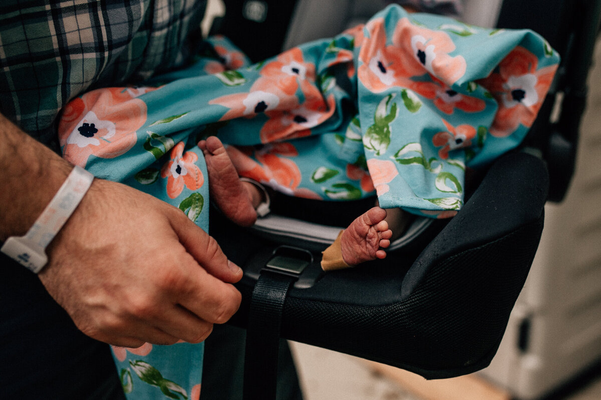 Newborn baby being held.