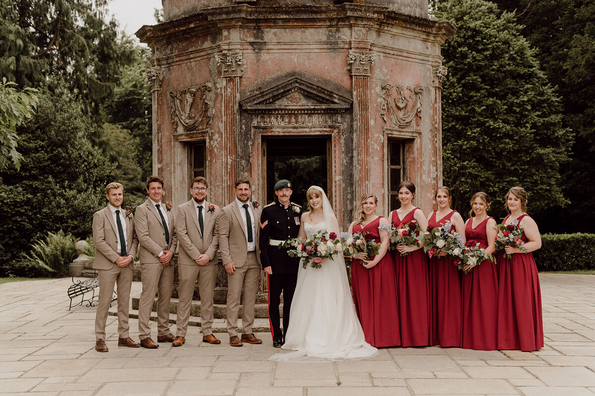 wedding party in red, white, and tan