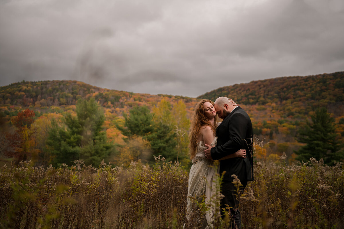 couple kissing with the mountain views in the background of their elopement location