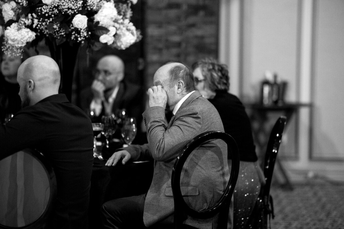 Guest wiping tear during speeches at wedding reception in Paradise Valley, Arizona
