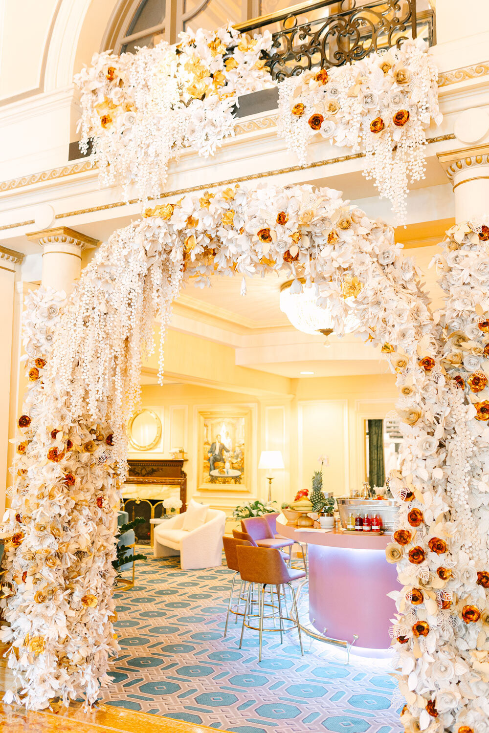 Floral wedding arch with cascading white and gold flowers