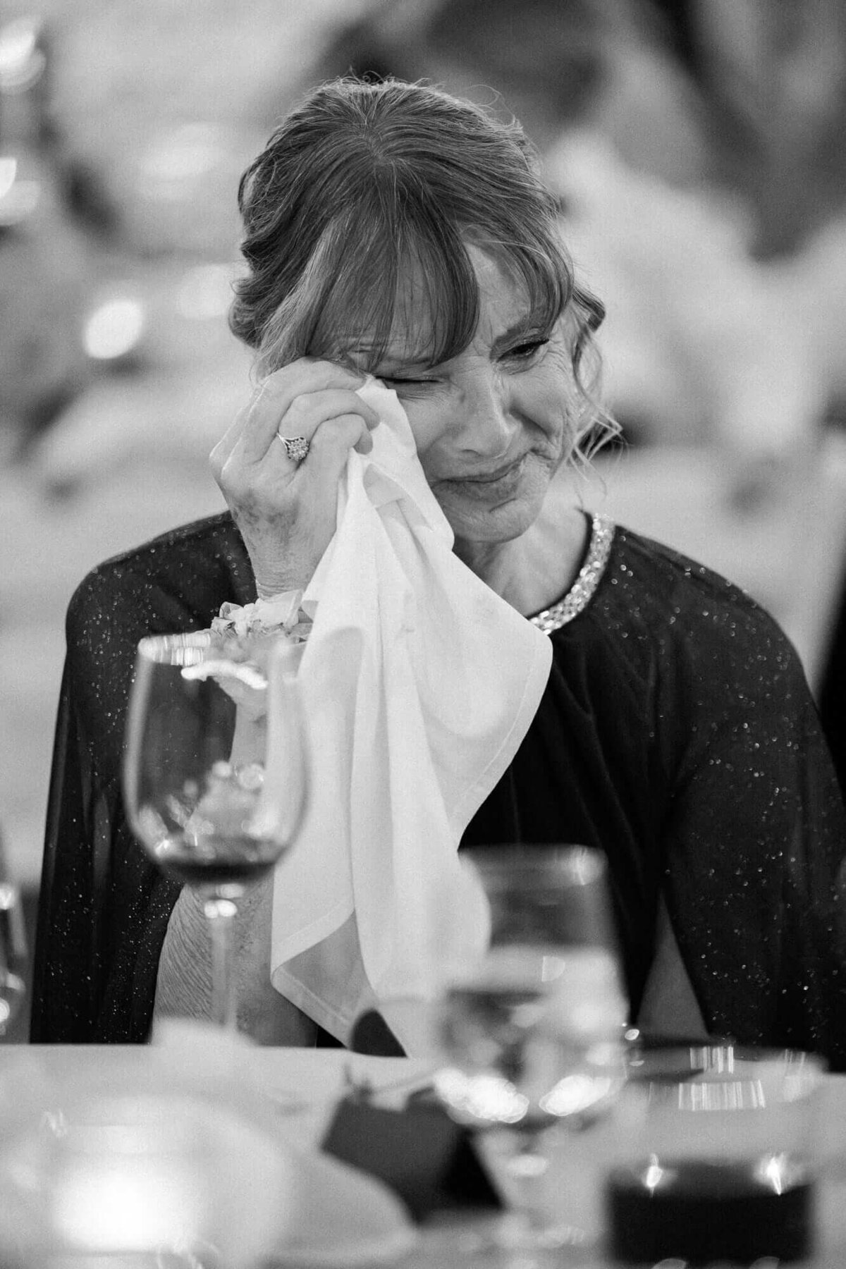 Emotional wedding moment at Mountain Shadows in Scottsdale, Arizona, as a guest wipes away tears during the reception speeches.