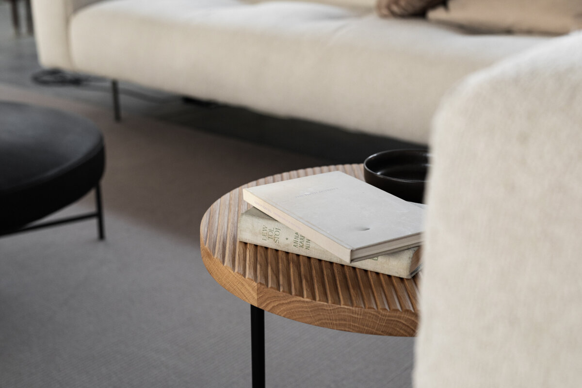 kaboompics_wooden-fluted-table-books-light-beige-sofa-oak-boucle-25042