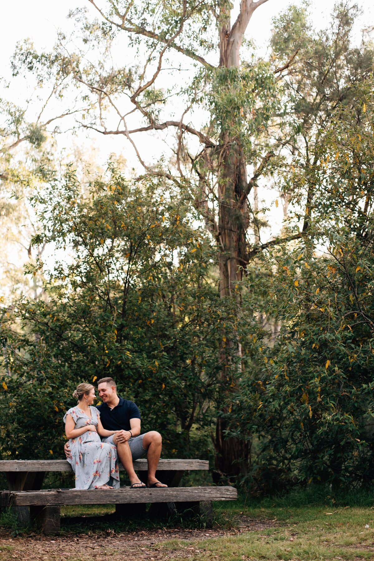 couple maternity session, sitting on bench together at Pound Bend Warrandyte