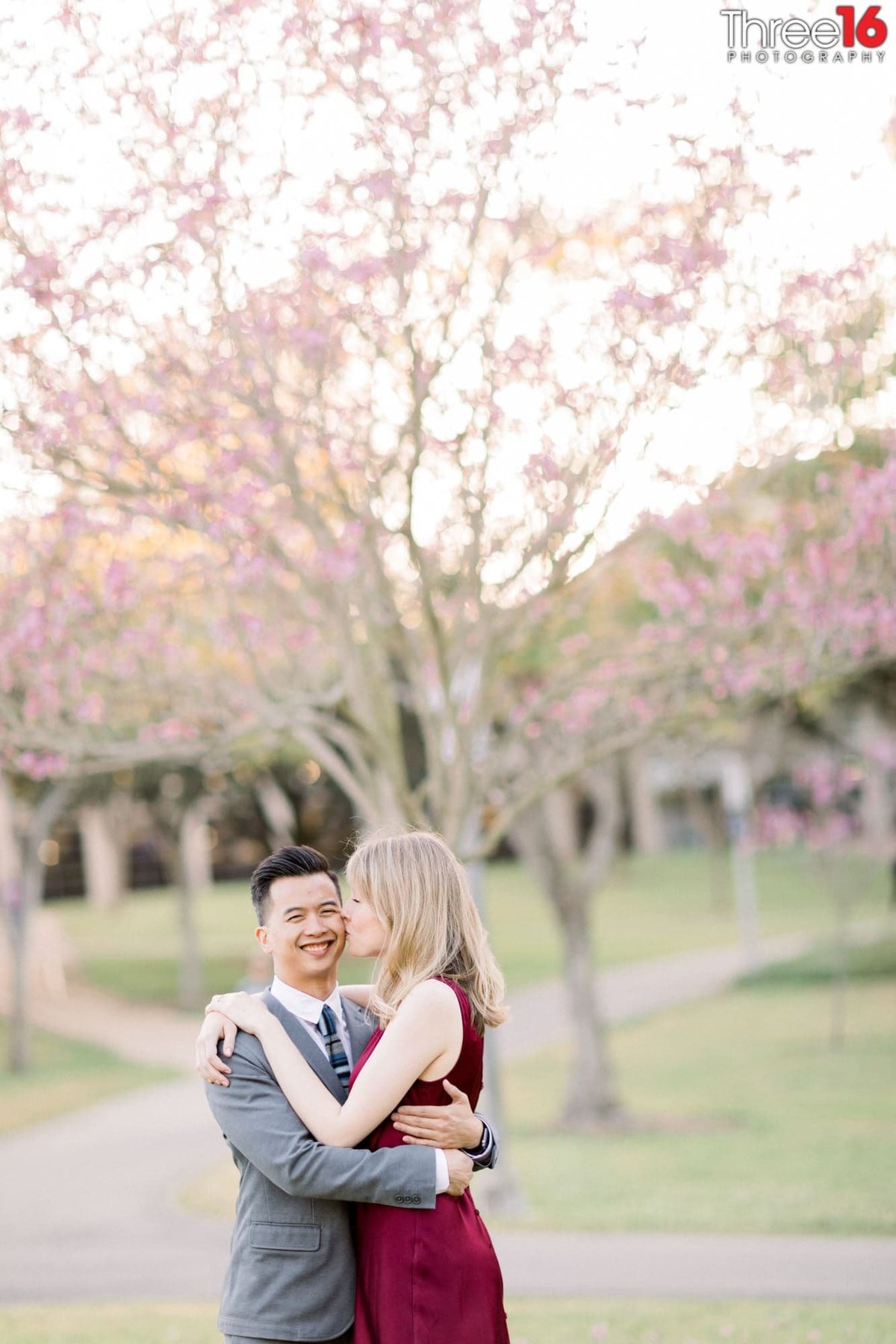 Bride to be kisses her Groom as he embraces her