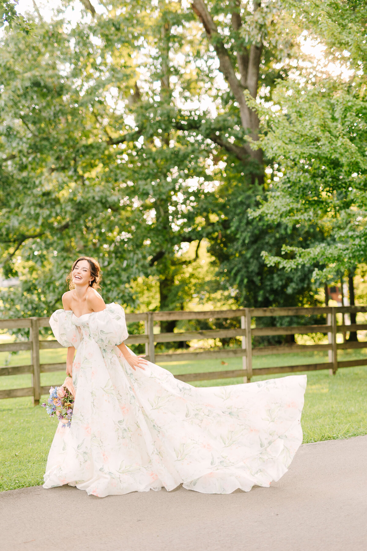 bridal portrait of bride smiling in floral wedding dress holding bouquet winx photo knoxville wedding photographer