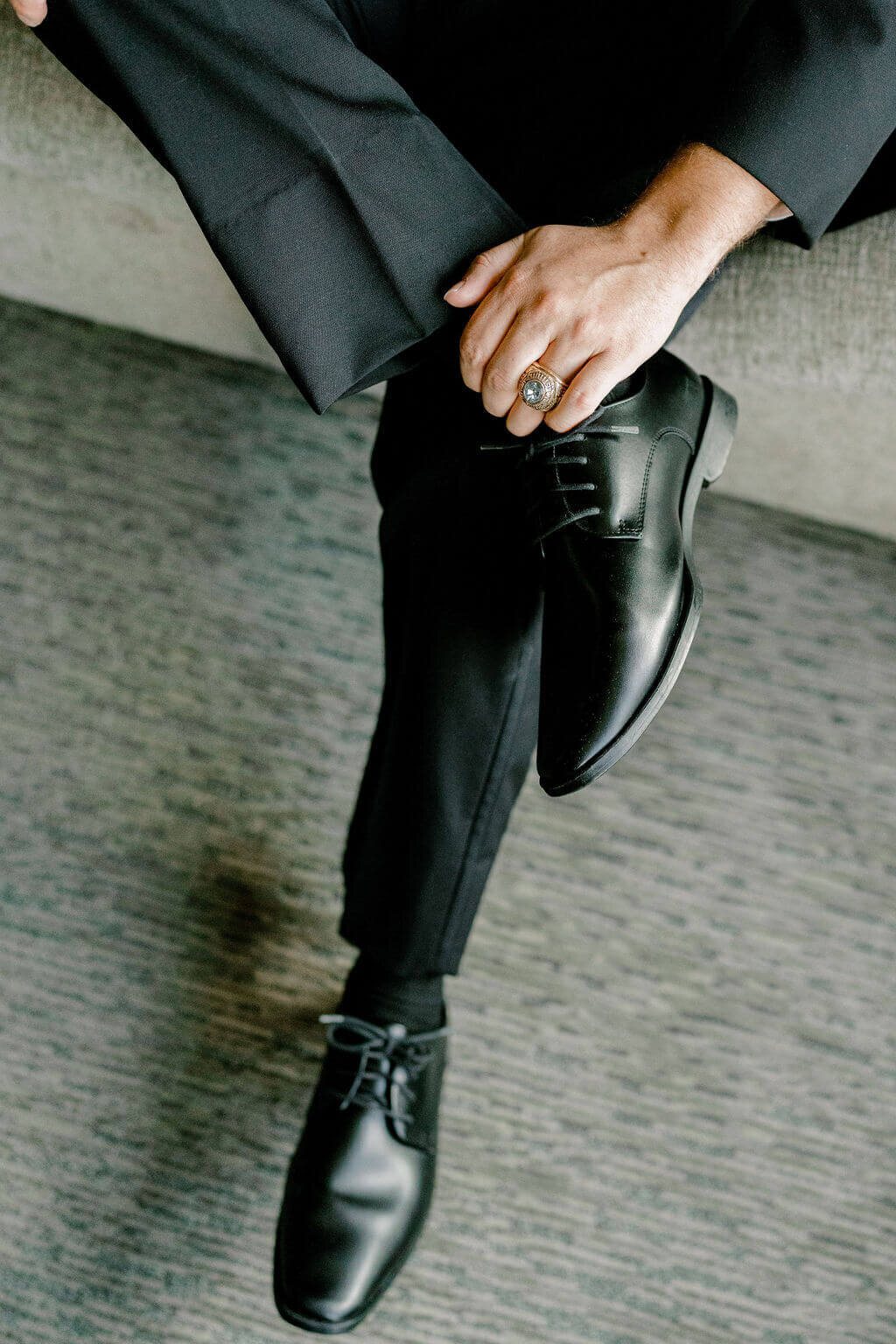Detailed, close up photo of groom's shoes and family ring during getting ready photos