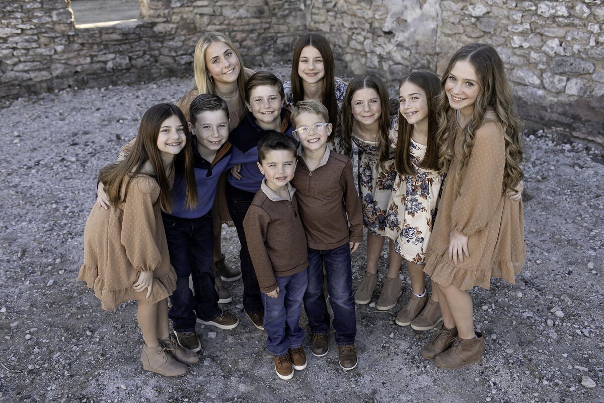 A heartwarming photoshoot of cousins with their grandma, sharing love, smiles, and laughter, creating a beautiful family moment
