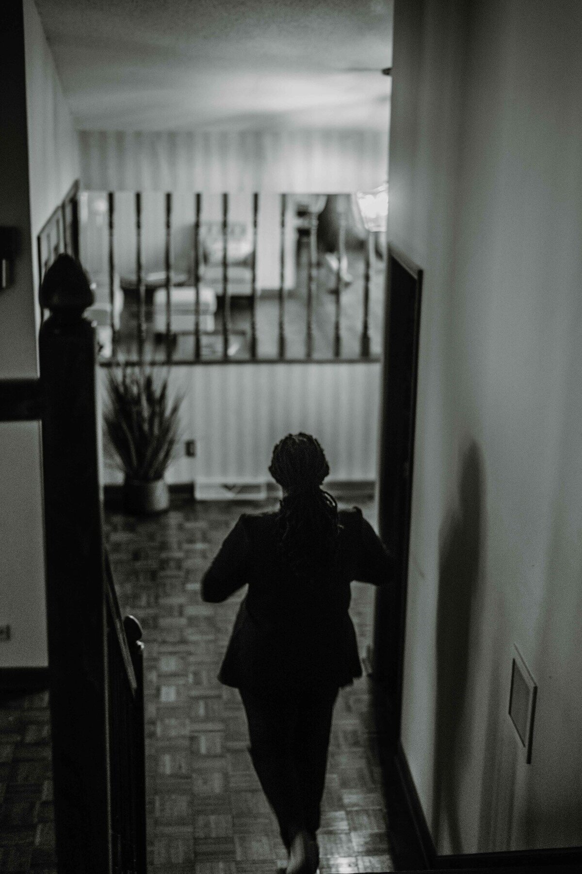 female arriving to her wedding day black and white walking down stairs