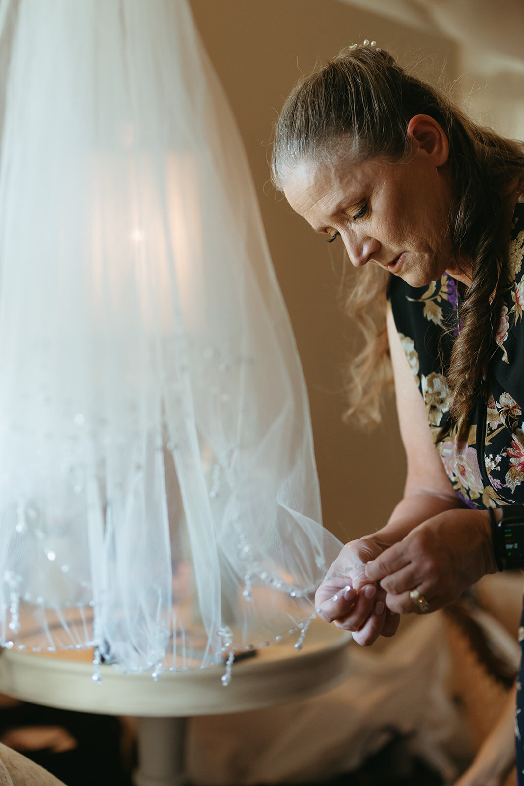 woman adds embroidery to wedding veil