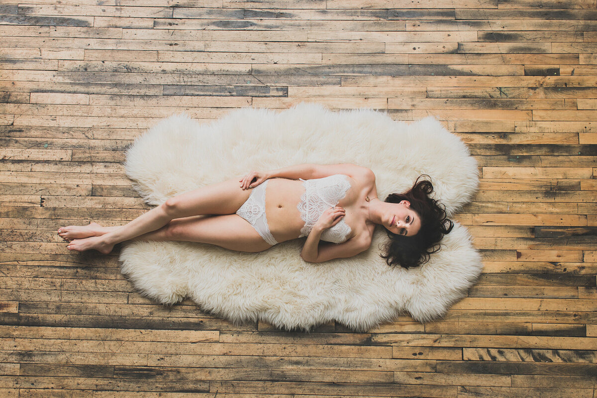A light and airy boudoir photo captured from overhead at a loft space in Chicago.