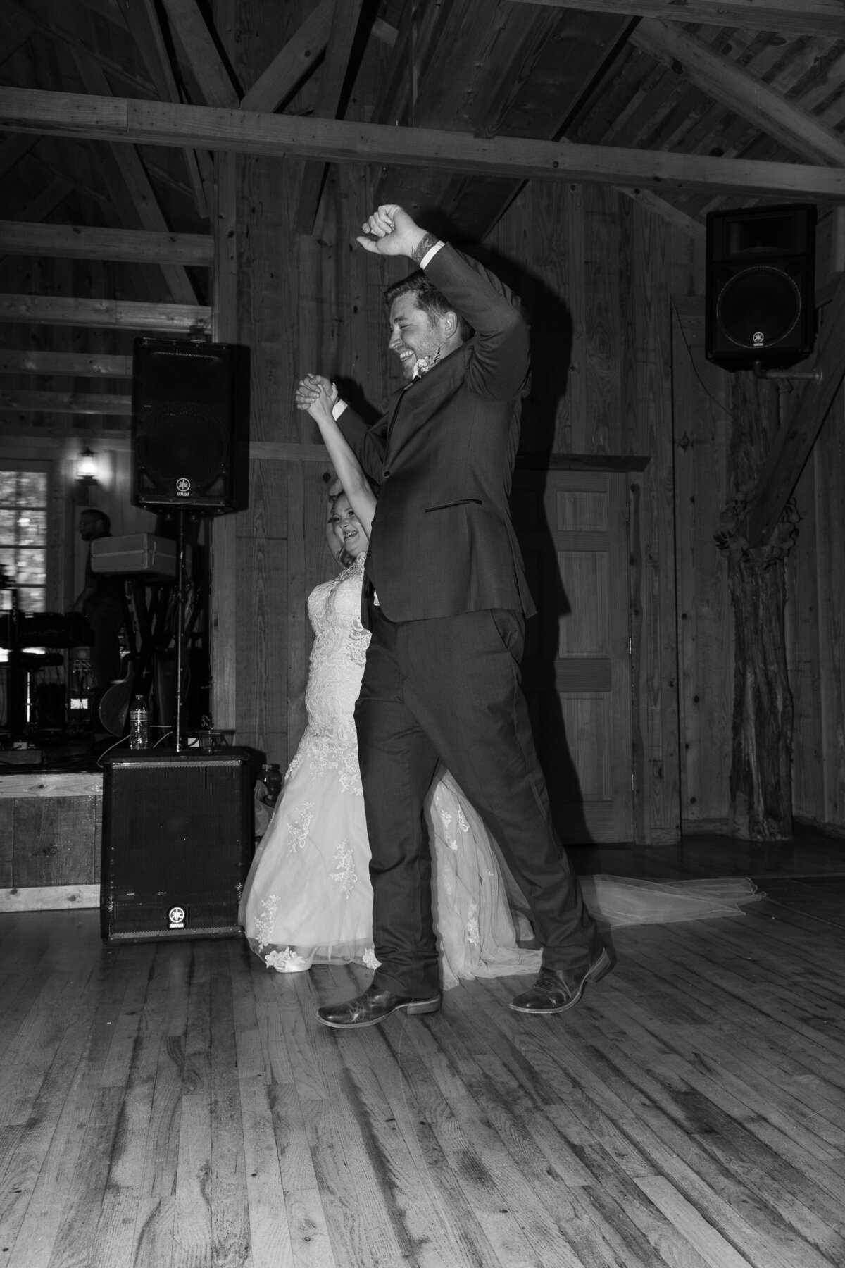 Austin wedding photographer capturing a bride and groom gracefully dancing in a charming barn.