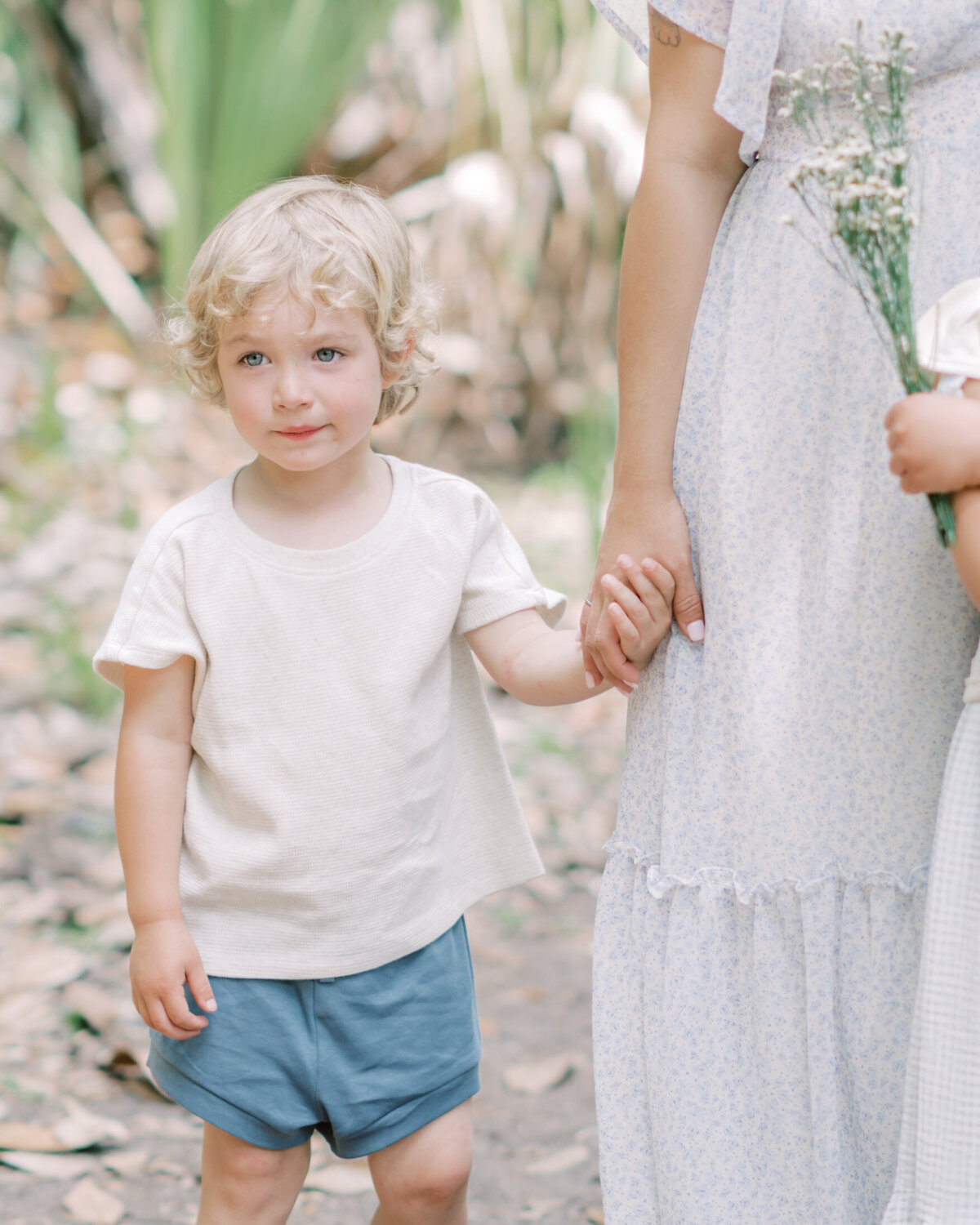 Detail portrait of a little boy holding his mother's hand by Savannah Family Photographer Courtney Cronin