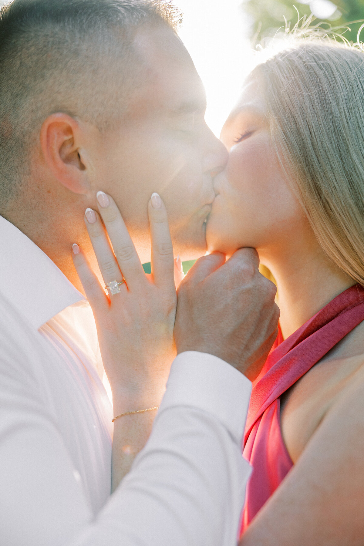 Close-up of engaged couple kissing in sunny Columbus session by Philadelphia photographer.