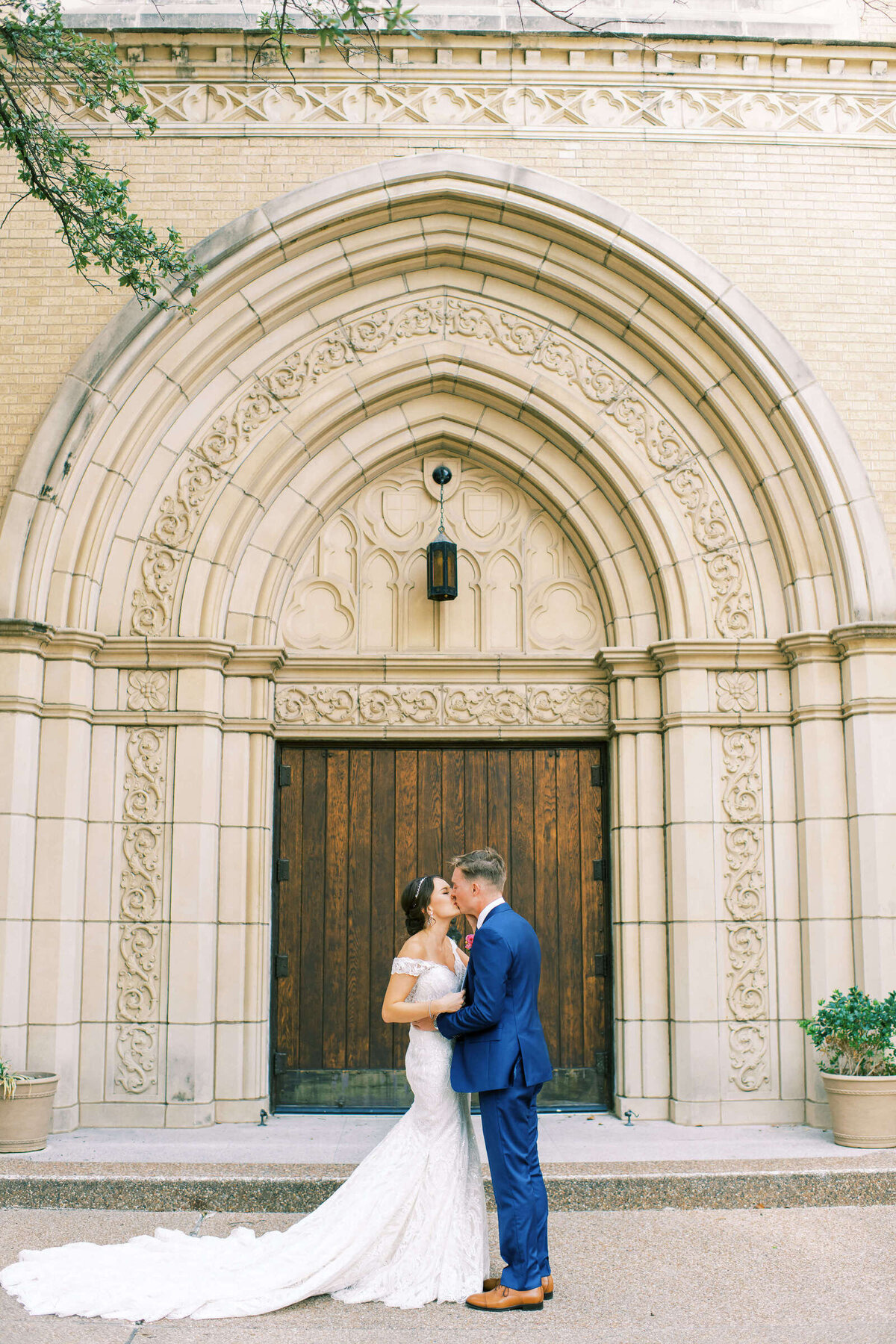 First look with bride and groom in front of ornate wedding chapel in Fort Worth