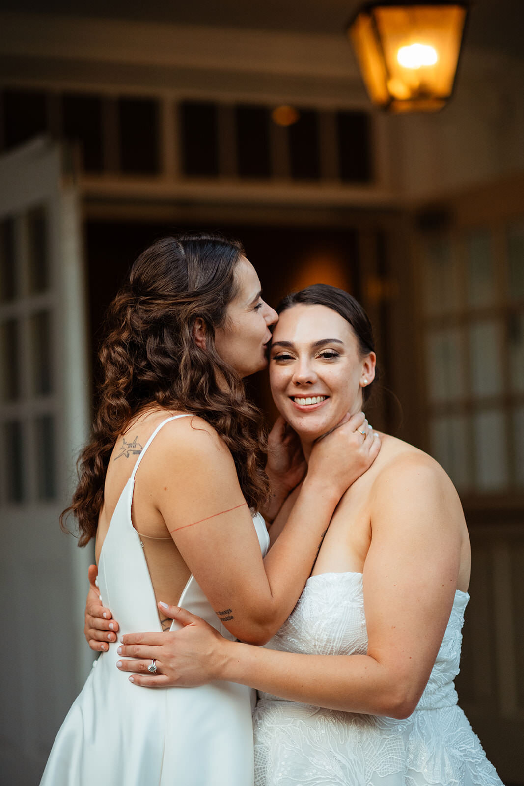 Bride kissing her bride's forehead